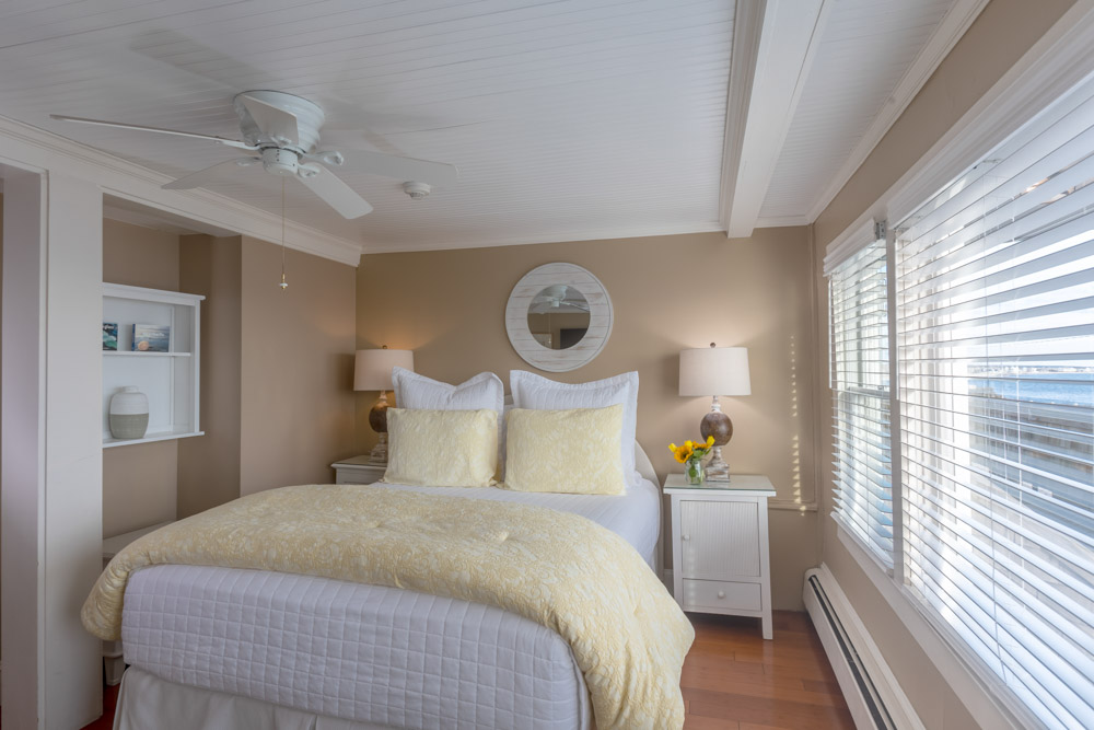 cape cod oceanfront bed and breakfast room with view and white bed and end tables