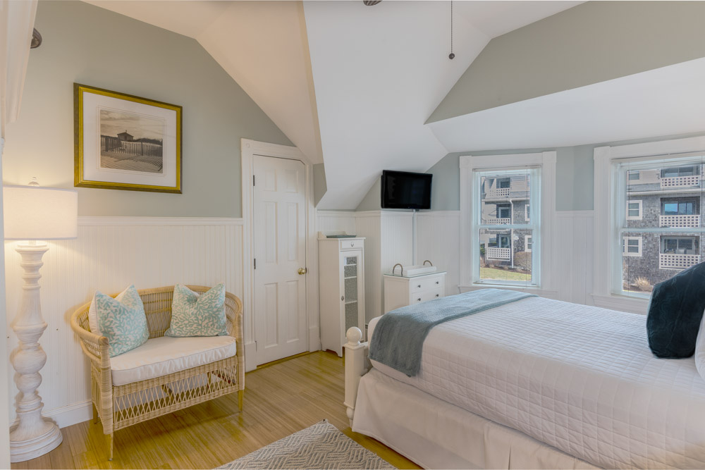 cape cod oceanfront bed and breakfast room with view and white bed and sitting couch